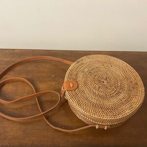 Round hand woven cross body Bali Bag. Lining is a unique purple fabric.